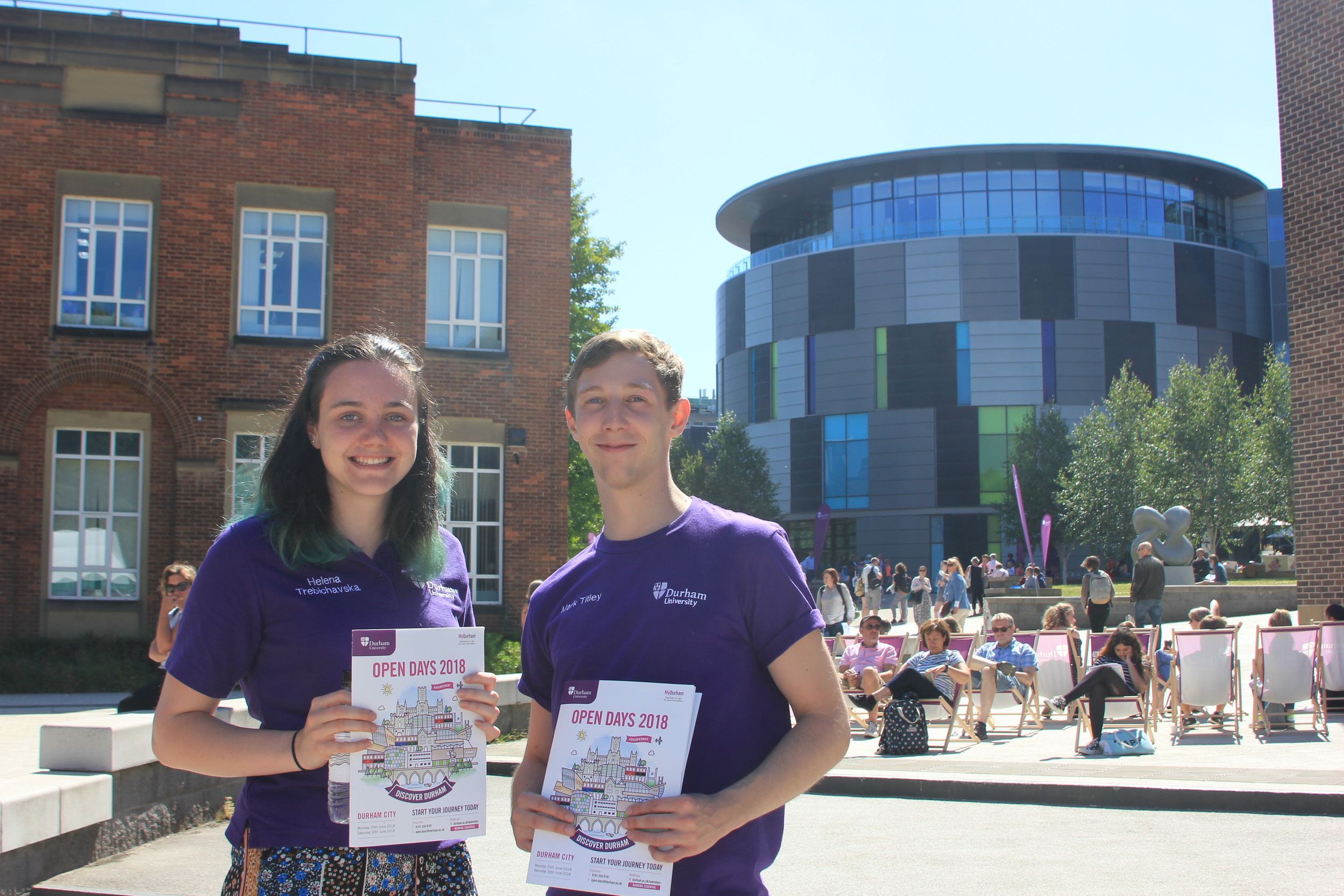 TTwo ֱ students on campus with open day brochures